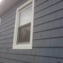 Gray siding and a white window