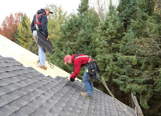 2 workmen installing a shingle roof